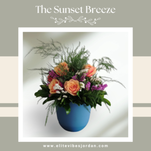 Bouquet of peach roses with purple and white filler flowers in a blue ceramic pot, with lush greenery.