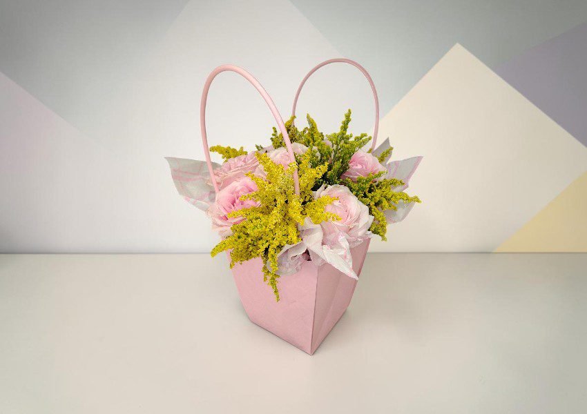 IMG_20260624_192608 1 | Elite Vibes - Jordan Pink gift bag filled with pink roses and bright yellow filler flowers, with tissue paper peeking out.